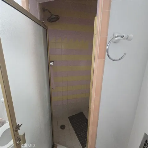 a bathroom with a glass shower door
