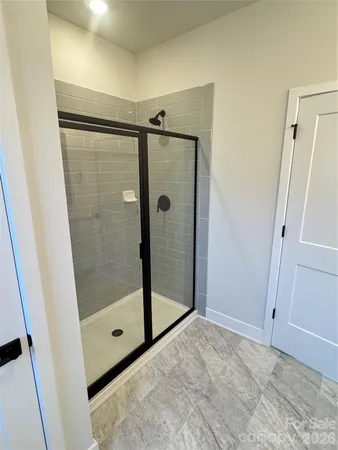 a bathroom with a shower and a glass door