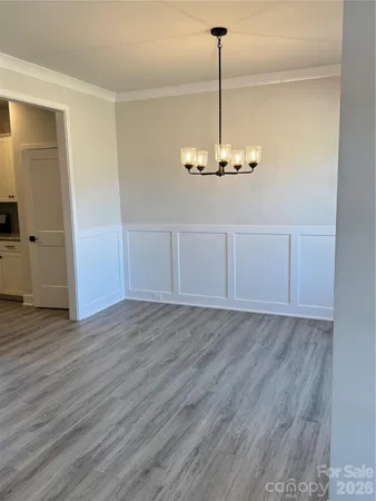 a view of a chandelier fan and wooden floor