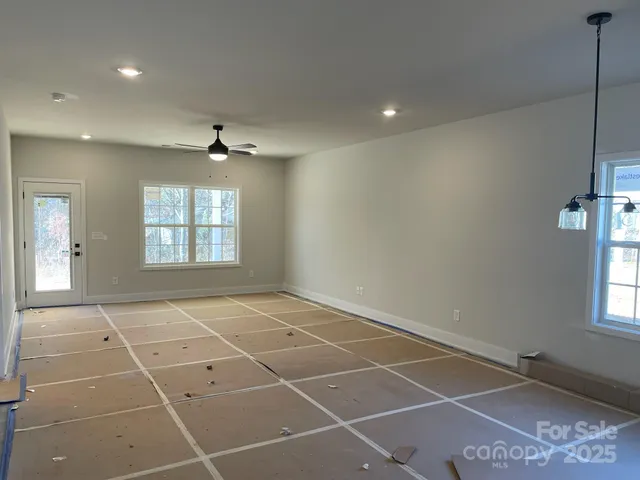 a view of a room with kitchen and window