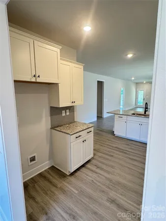 a large kitchen with stainless steel appliances granite countertop a stove and a sink