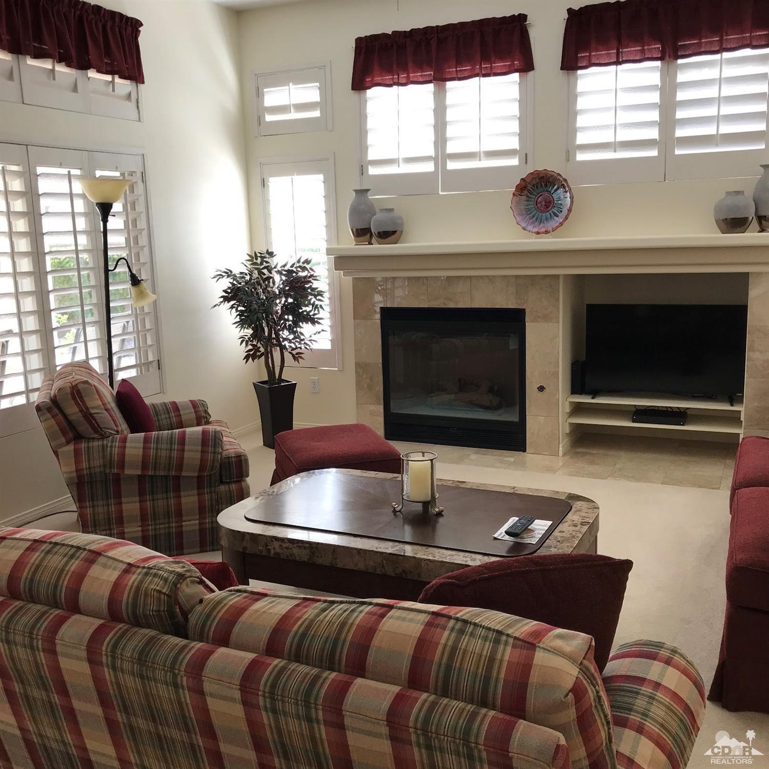 78121 Hunter Point Road Palm Desert, CA 92211 - Photo 4 of 12 a living room with furniture and a fireplace