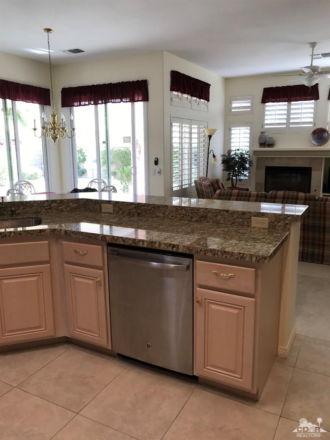 78121 Hunter Point Road Palm Desert, CA 92211 - Photo 6 of 12 a kitchen with granite countertop a sink and a window
