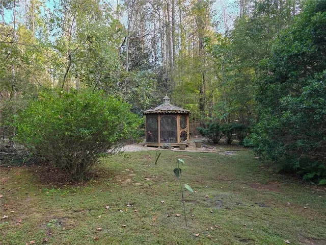 a backyard of a house with table and chairs