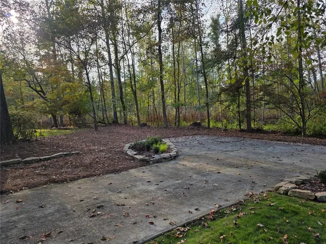 a view of a backyard with large trees