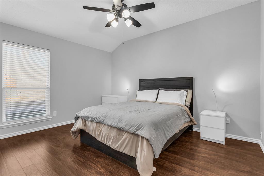 308 Glen Ridge Drive Murphy, TX 75094 - Photo 16 of 36 a bedroom with a bed and wooden floor