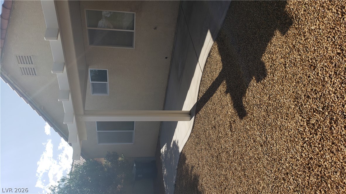 9112 Manalang Road Las Vegas, NV 89123 - Photo 11 of 50 A spacious covered patio provides a shaded retreat from the sun, adjacent to low-maintenance landscaping.