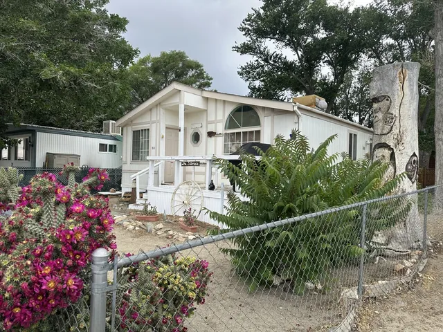 a view of a house with wooden fence