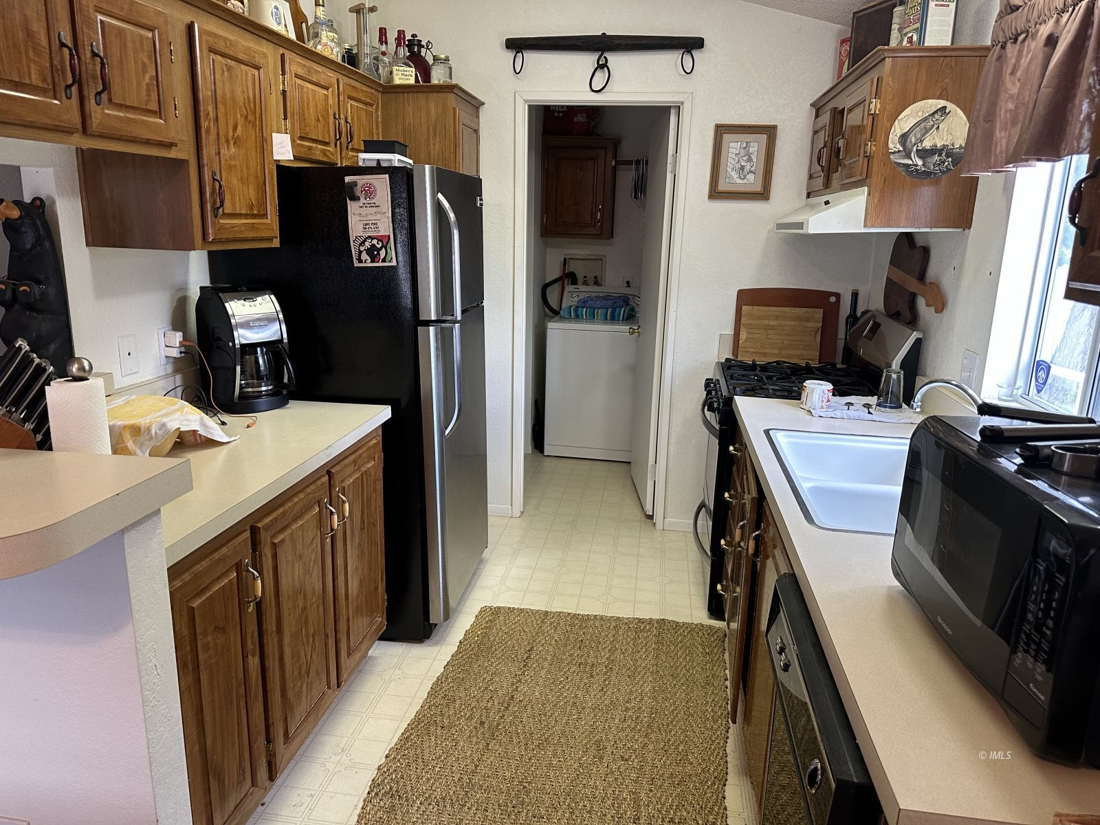 150 Tinnemaha Road, Unit C2 Big Pine, CA 93513 - Photo 13 of 28 a kitchen with stainless steel appliances granite countertop a refrigerator stove and sink