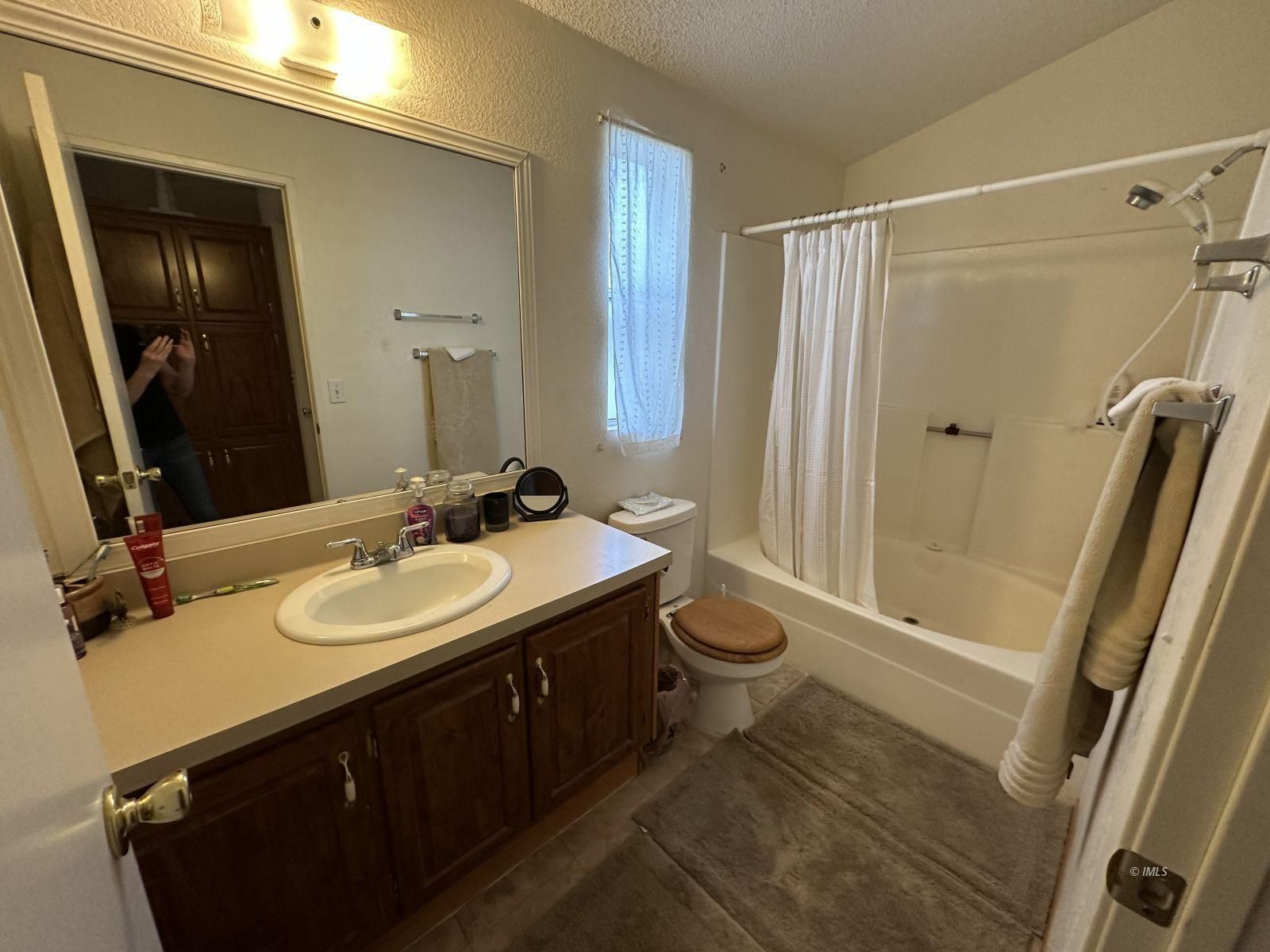 150 Tinnemaha Road, Unit C2 Big Pine, CA 93513 - Photo 14 of 28 a bathroom with a sink a toilet a mirror and shower