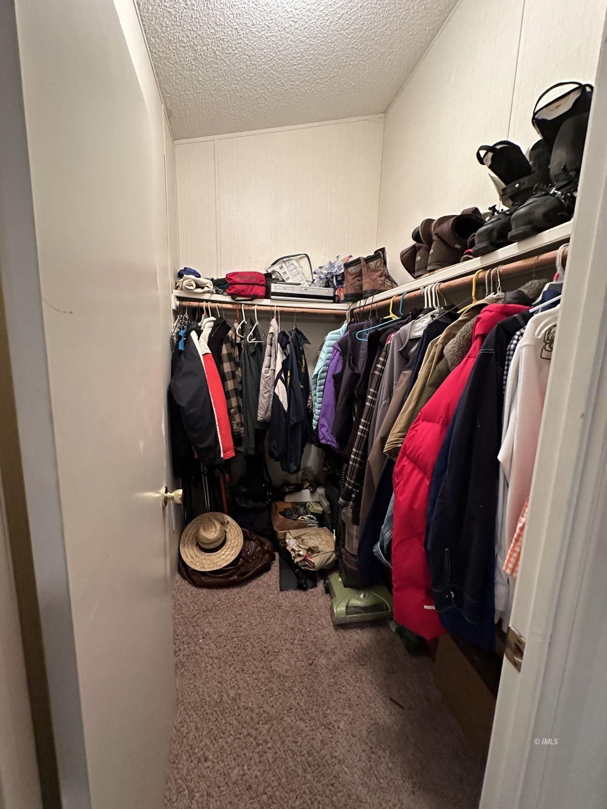 150 Tinnemaha Road, Unit C2 Big Pine, CA 93513 - Photo 15 of 28 a view of walk in closet with clothes