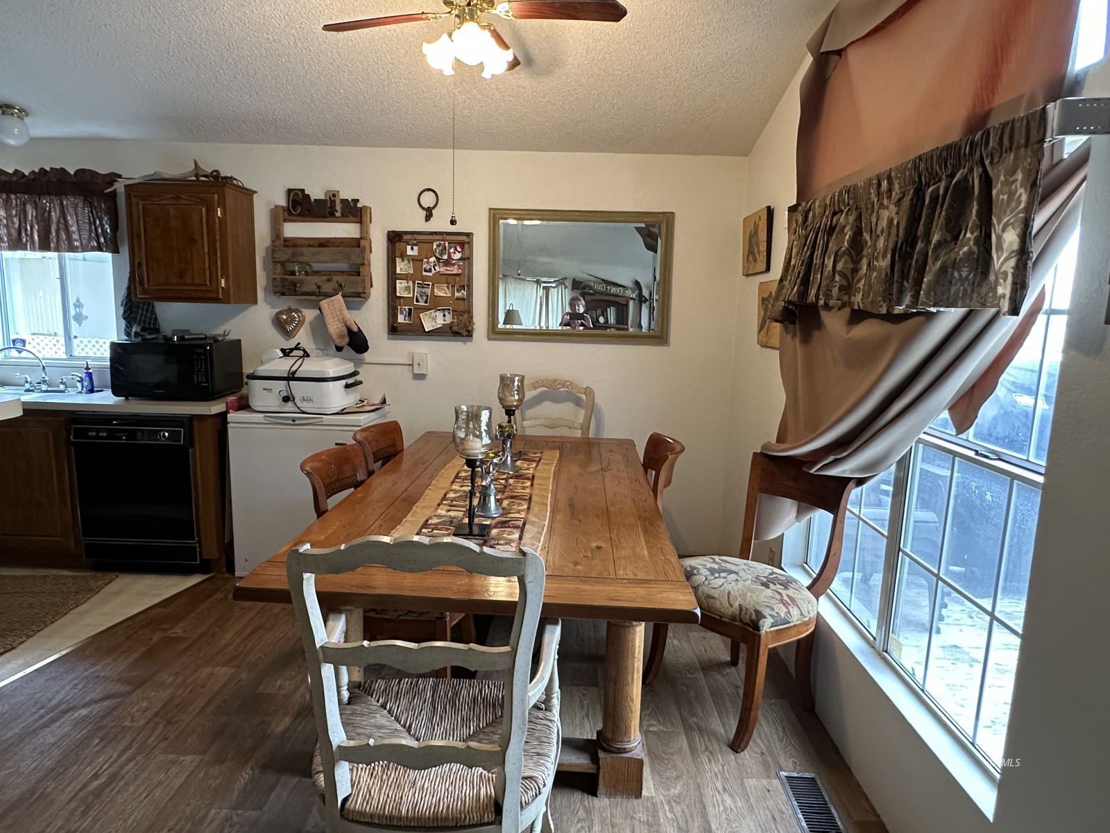 150 Tinnemaha Road, Unit C2 Big Pine, CA 93513 - Photo 3 of 28 a view of a dining room with furniture a kitchen and chandelier