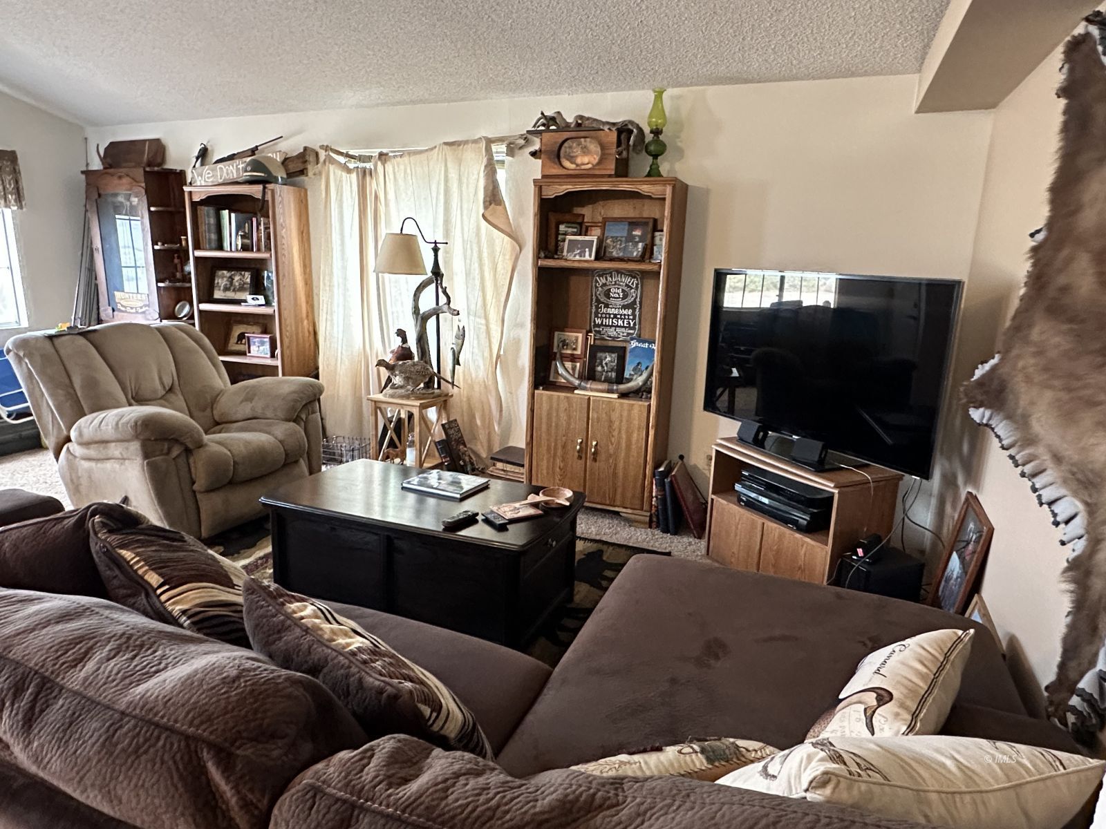 150 Tinnemaha Road, Unit C2 Big Pine, CA 93513 - Photo 4 of 28 a living room with furniture and a flat screen tv