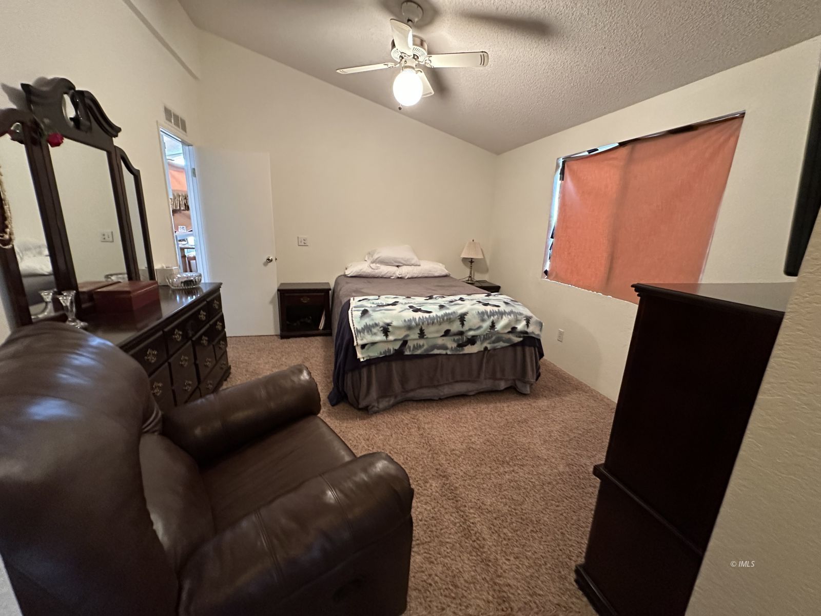150 Tinnemaha Road, Unit C2 Big Pine, CA 93513 - Photo 6 of 28 a bedroom with furniture and a flat tv screen