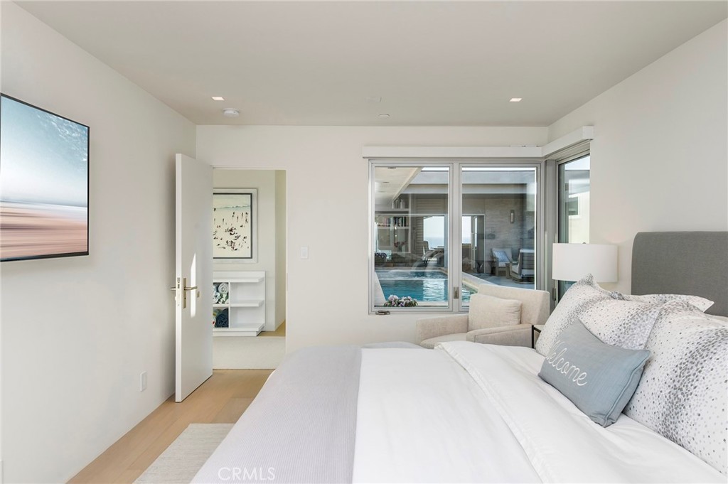 37 Monarch Bay Drive Dana Point, CA 92629 - Photo 21 of 37 a large bedroom with a large bed and wooden floor