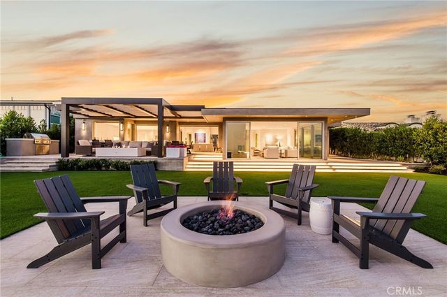 a view of a patio with couches potted plants and a swimming pool