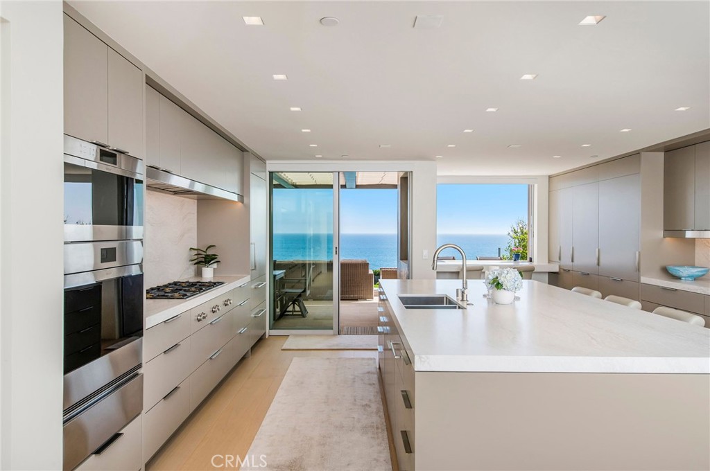 37 Monarch Bay Drive Dana Point, CA 92629 - Photo 9 of 37 a large kitchen with stainless steel appliances a large counter top a stove and a refrigerator