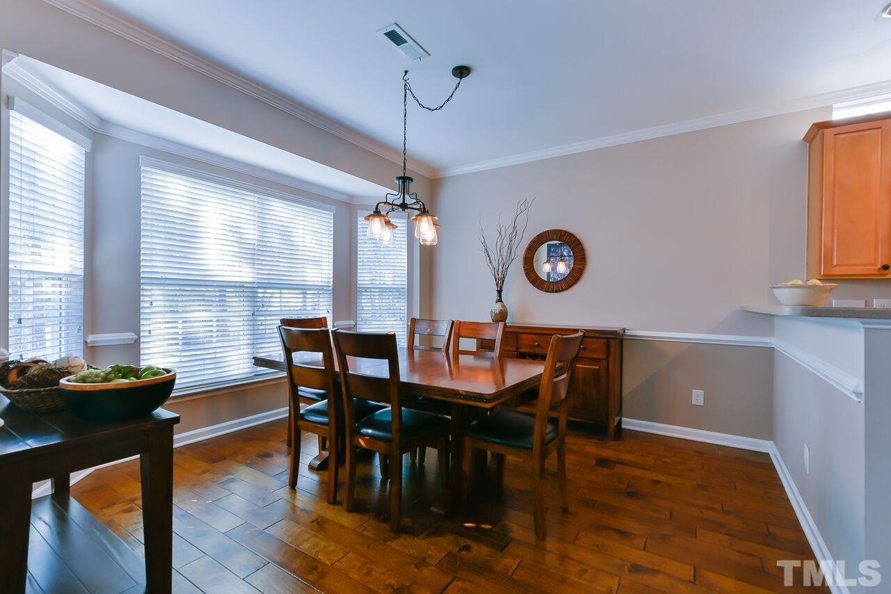 8415 Stone Mason Drive Raleigh, NC 27613 - Photo 3 of 9 a view of a dining room with furniture and window