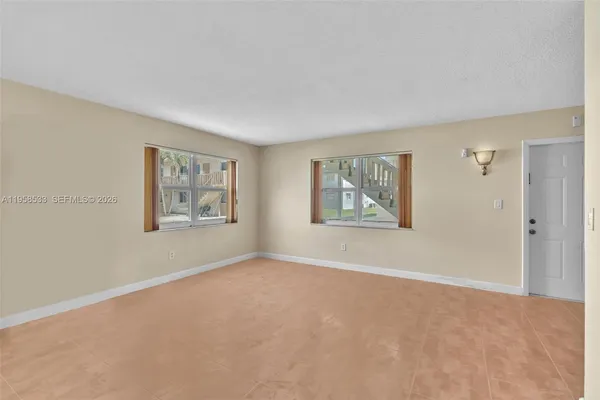 a view of a big room with window and closet