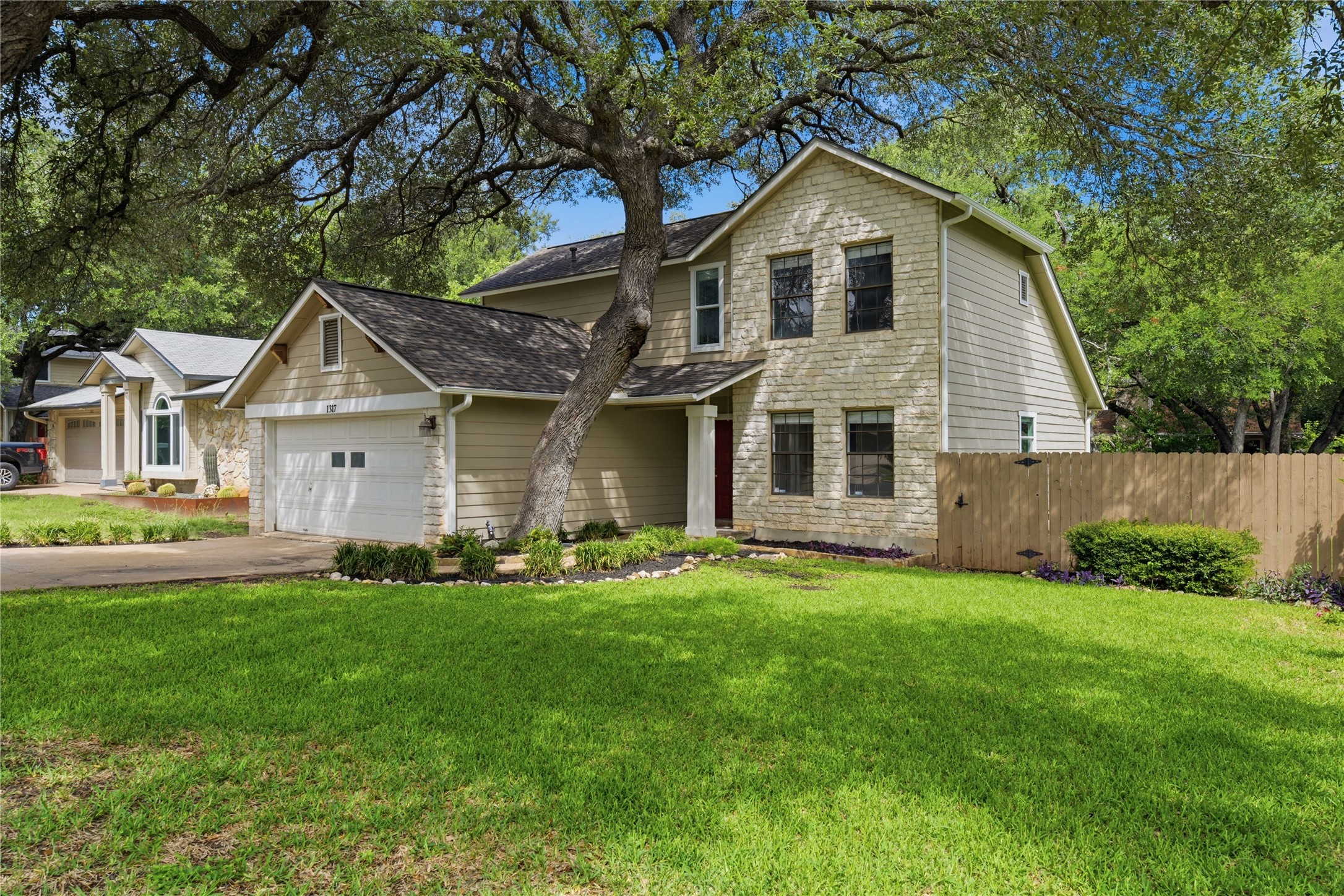 1317 Mimosa Pass Cedar Park, TX 78613 - Photo 2 of 20 a front view of a house with a yard and garage