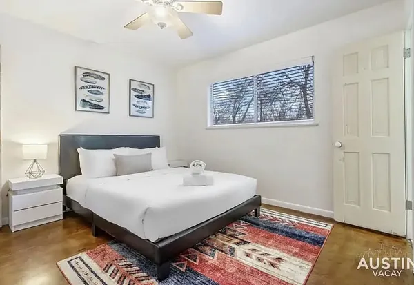 a bedroom with a bed and a night stand