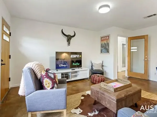 a living room with furniture and a flat screen tv
