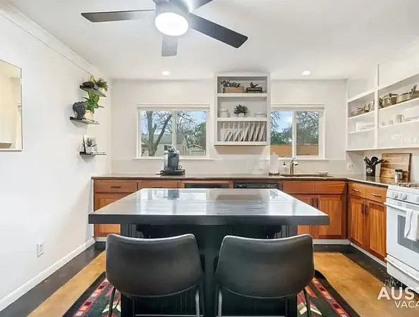 a kitchen with a table chairs a sink dishwasher window and cabinets