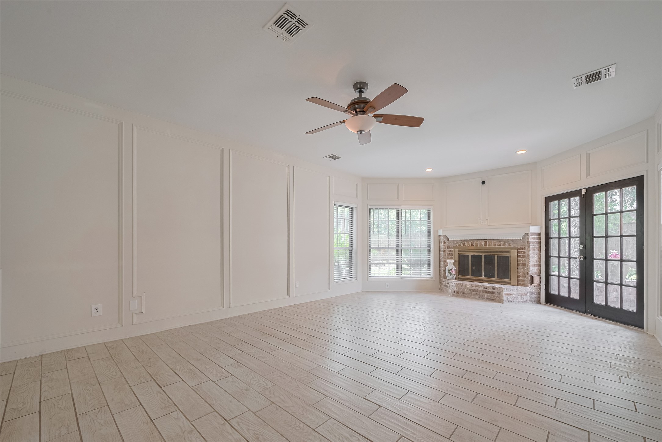 5210 Holly View Drive Houston, TX 77091 - Photo 3 of 31 Open family room with fireplace and french doors leading to back patio.