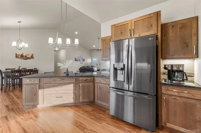 a kitchen with stainless steel appliances a refrigerator sink and cabinets