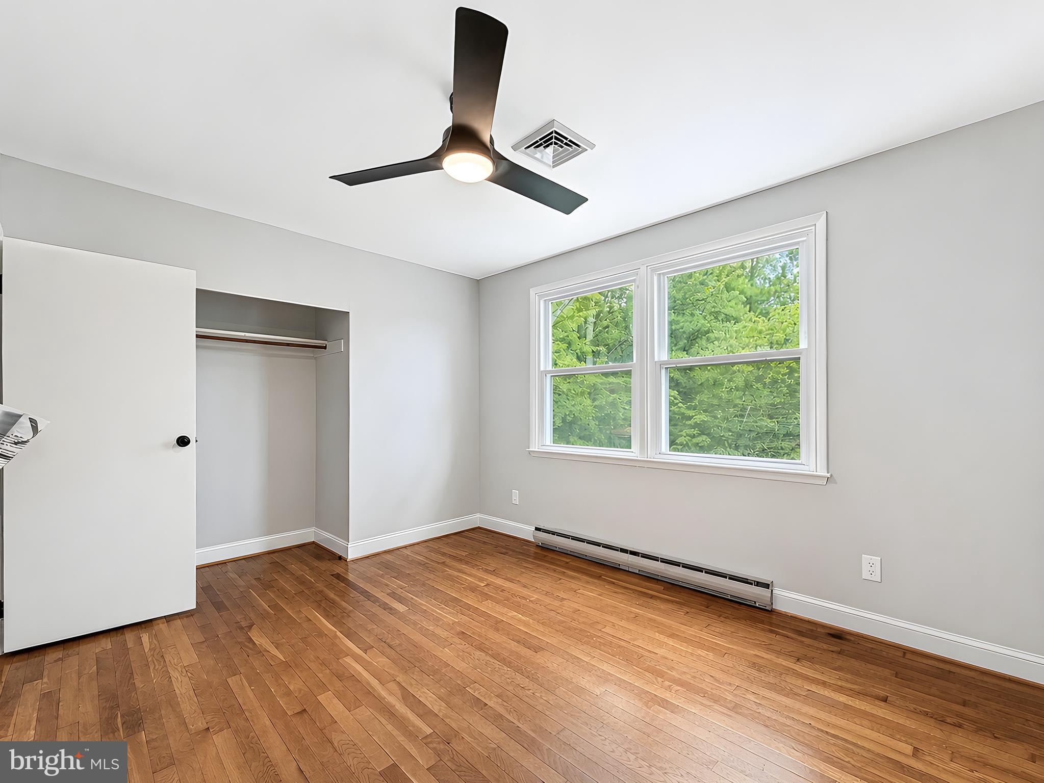 17248 Gum Landing Road St. Inigoes, MD 20684 - Photo 25 of 56 a view of an empty room with wooden floor and a window