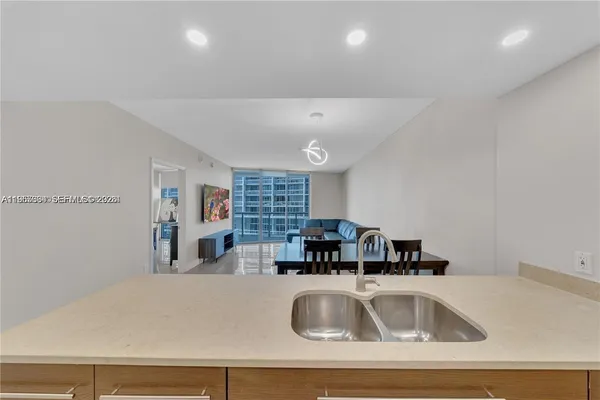 a kitchen with a sink a counter top space and furniture