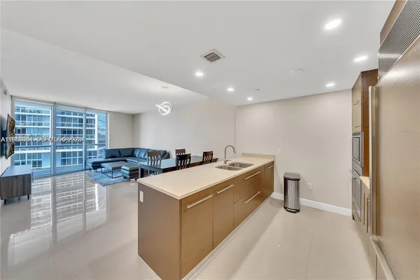 a large white kitchen with a large window