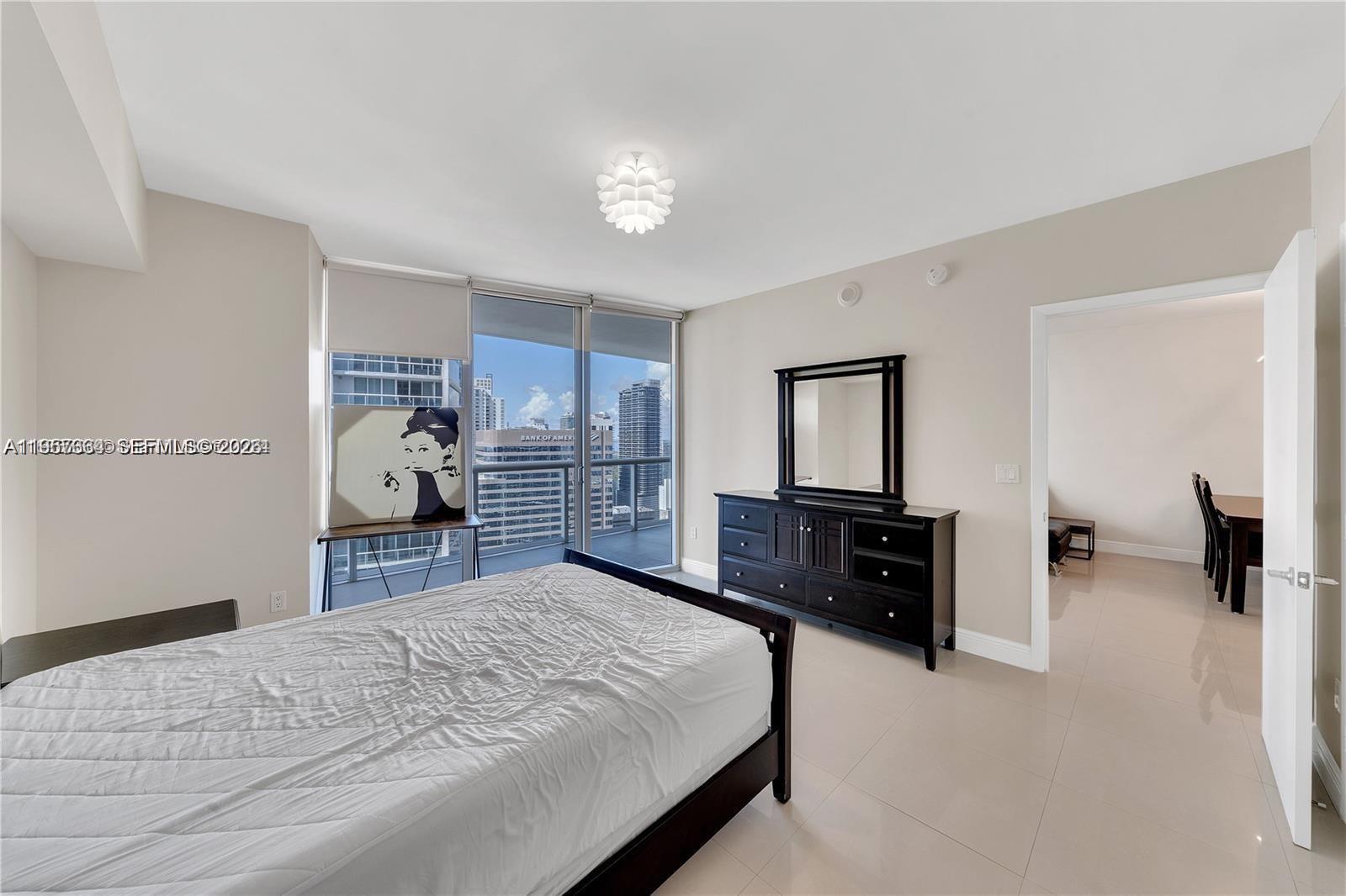 475 Brickell Avenue, Unit 4211 Miami, FL 33131 - Photo 7 of 10 a bed room with a bed and a television