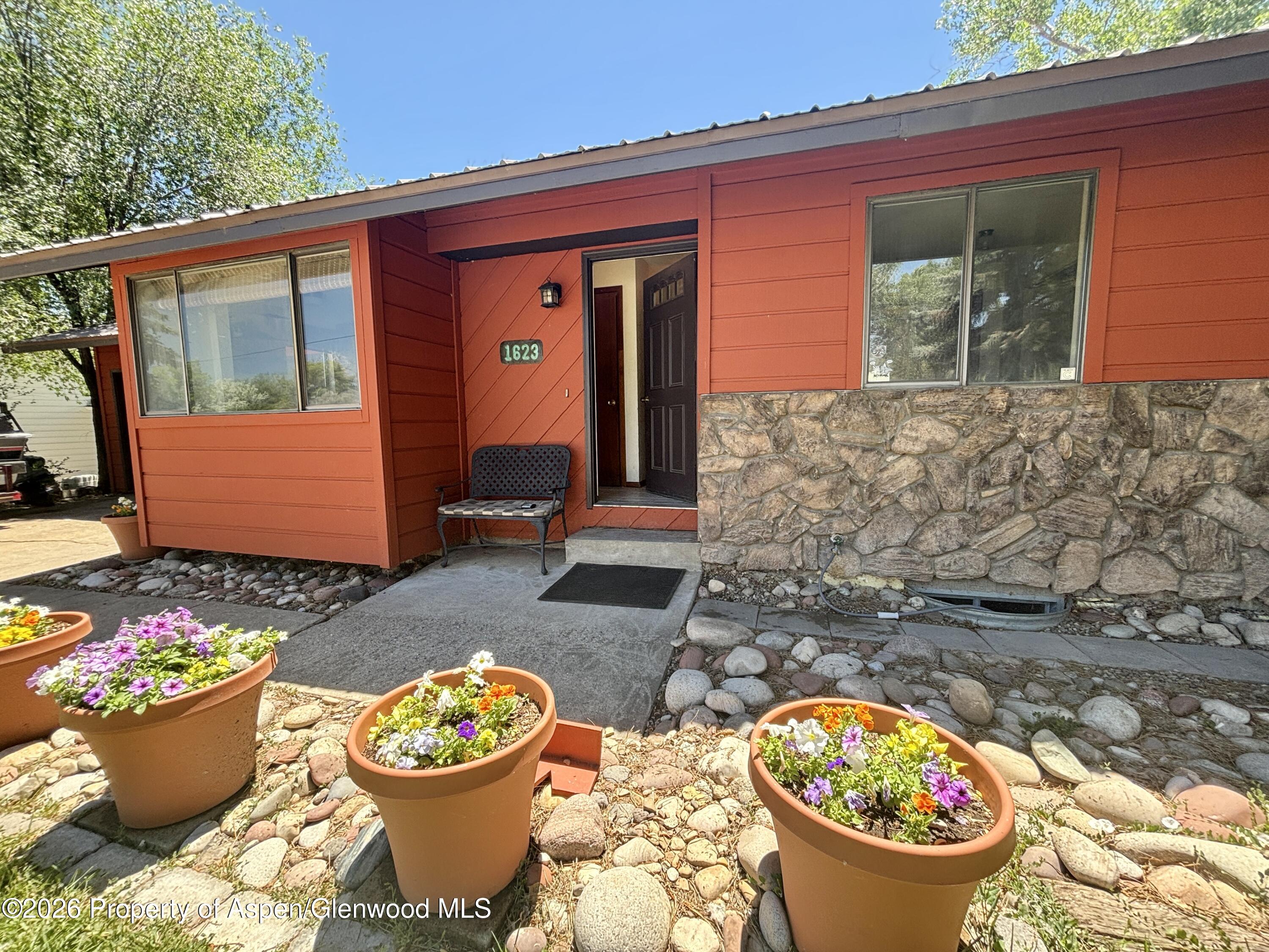 1623 West 7th Street Rifle, CO 81650 - Photo 1 of 21 a front view of a house with garden