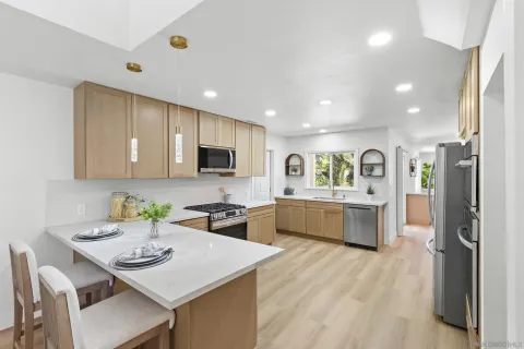 a kitchen with refrigerator and stove