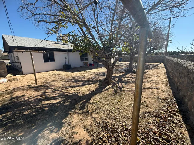 a house view with a yard covered in snow