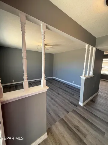 a view of an empty room with wooden floor