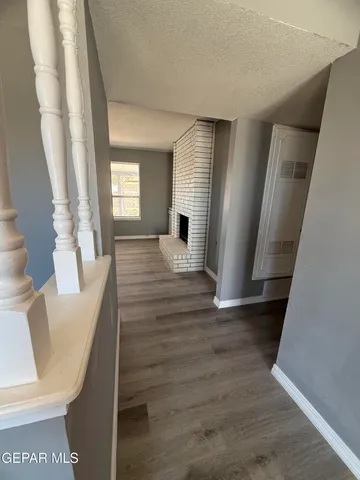 a view of a living room with furniture and wooden floor