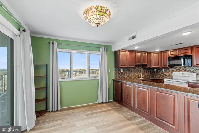 a view of a kitchen with a sink and a window