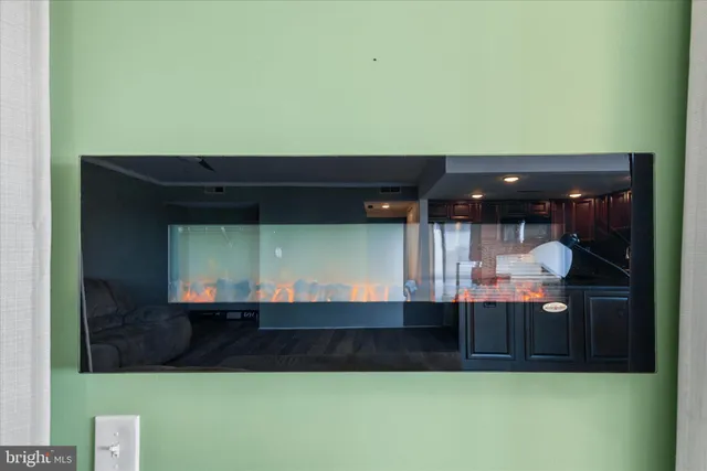 a kitchen with stainless steel appliances granite countertop a refrigerator a sink a stove a microwave and wooden cabinets