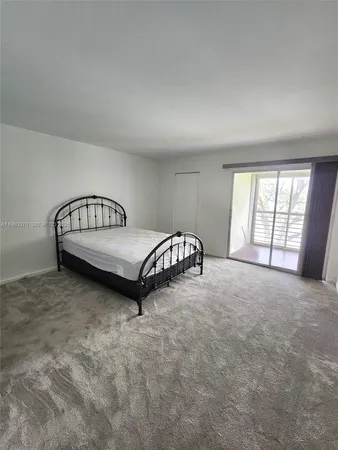 a view of a room with furniture and a window