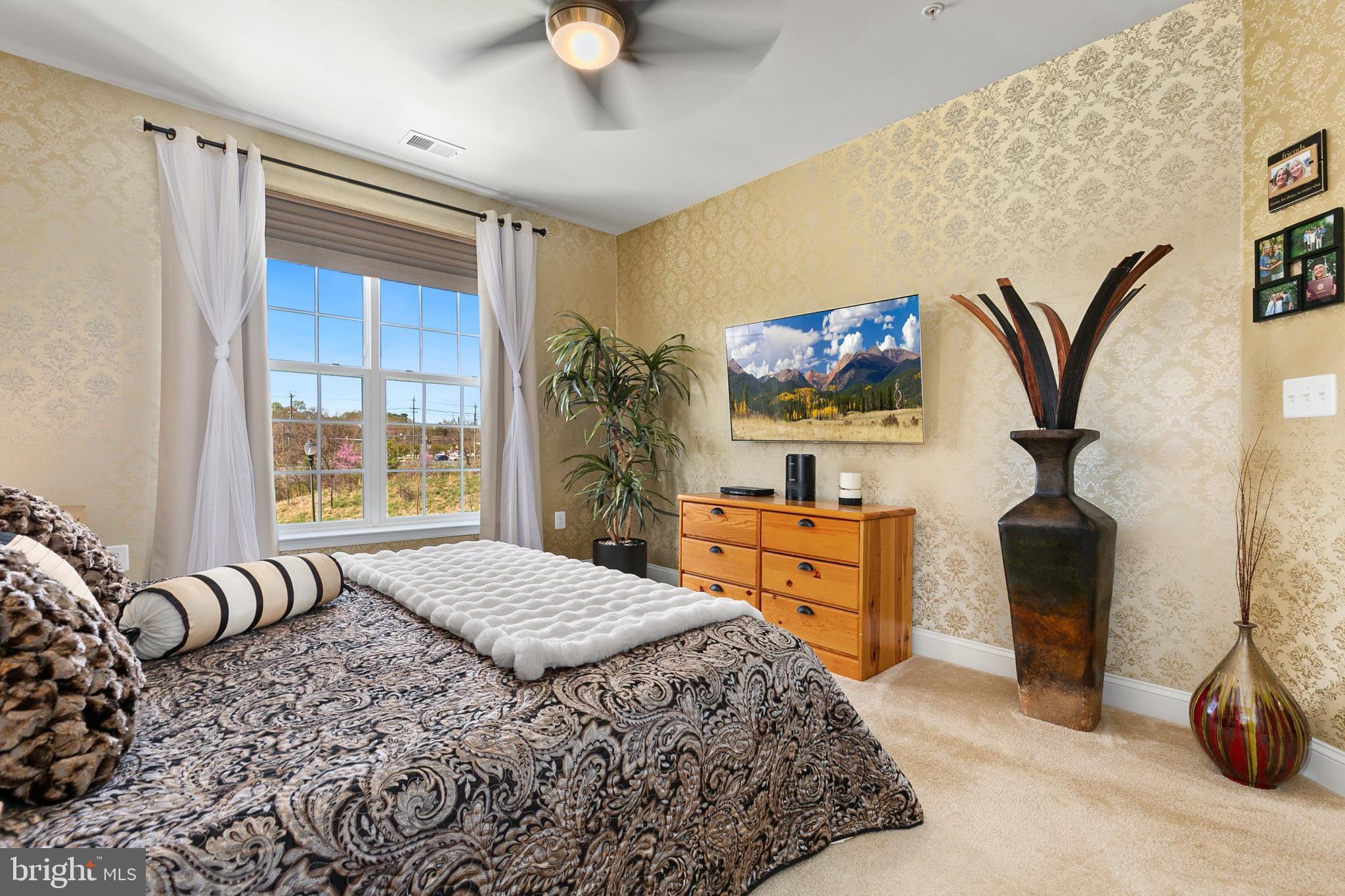 3825 Doc Berlin Drive, Unit 25 Silver Spring, MD 20906 - Photo 18 of 41 a bedroom with a bed and a chandelier