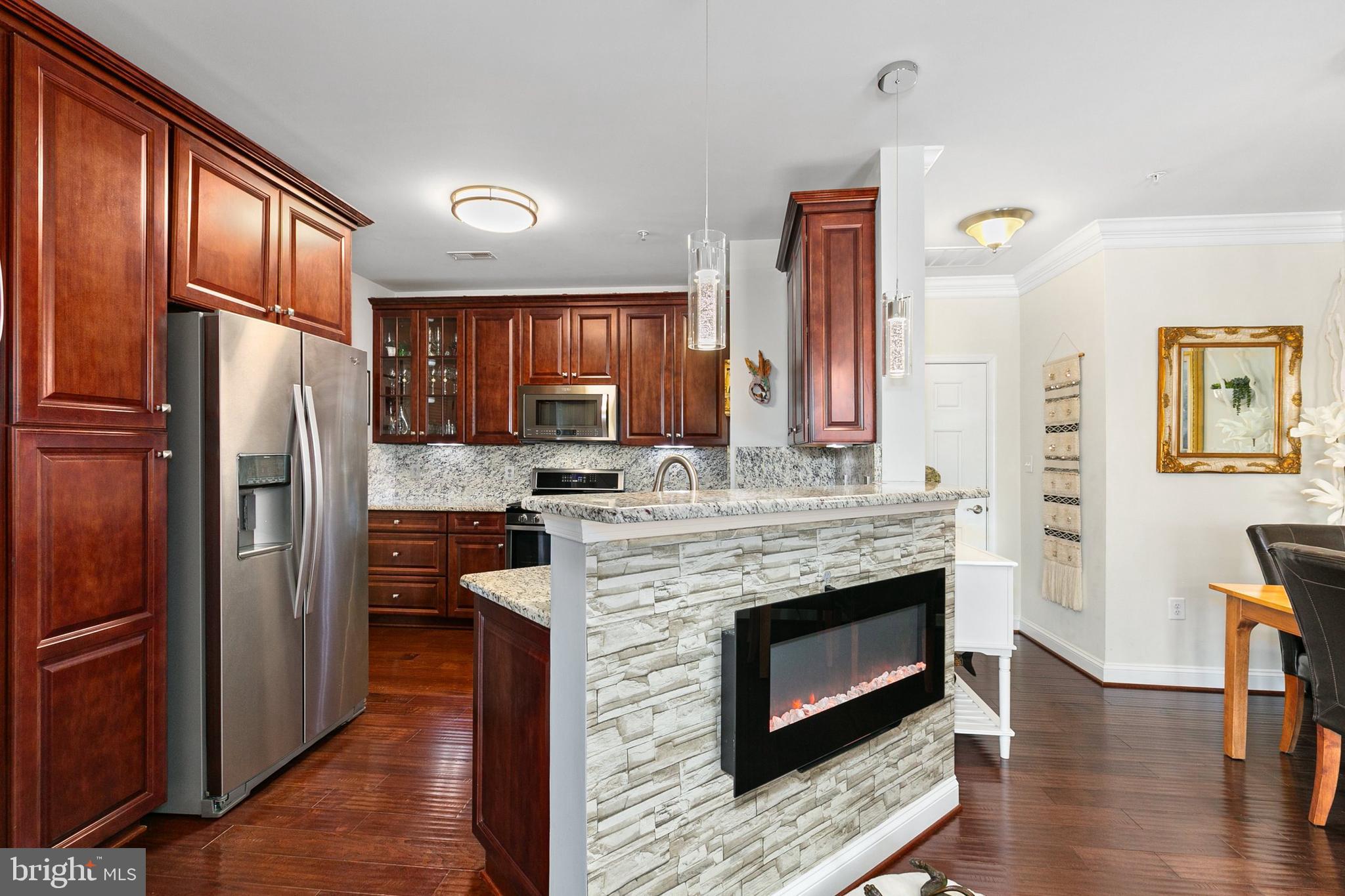 3825 Doc Berlin Drive, Unit 25 Silver Spring, MD 20906 - Photo 9 of 41 a kitchen with stainless steel appliances granite countertop a refrigerator and a stove