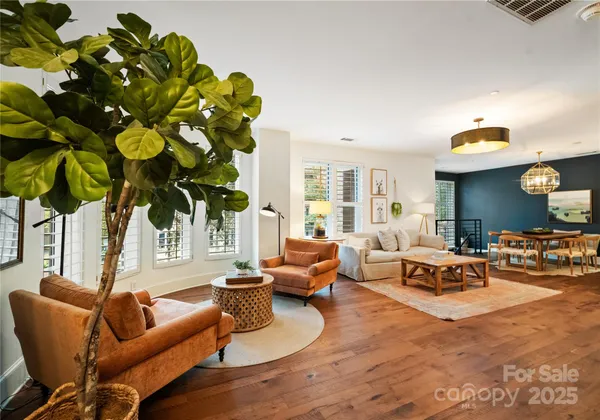 a living room with furniture and floor to ceiling windows