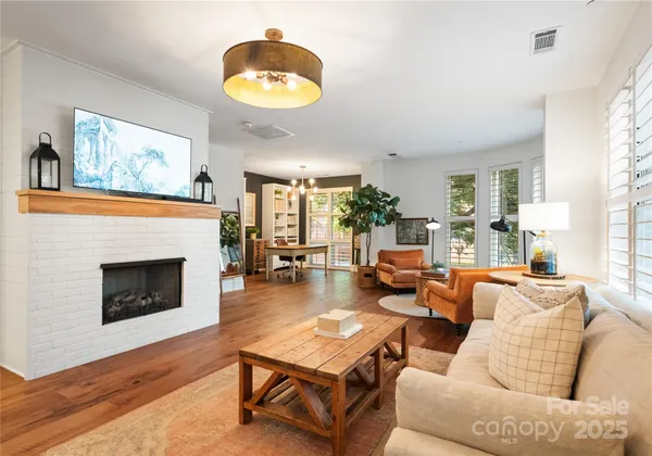 a view of a dining room with furniture wooden floor and a chandelier