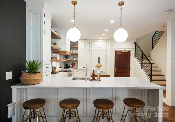 a kitchen with a refrigerator and a stove top oven
