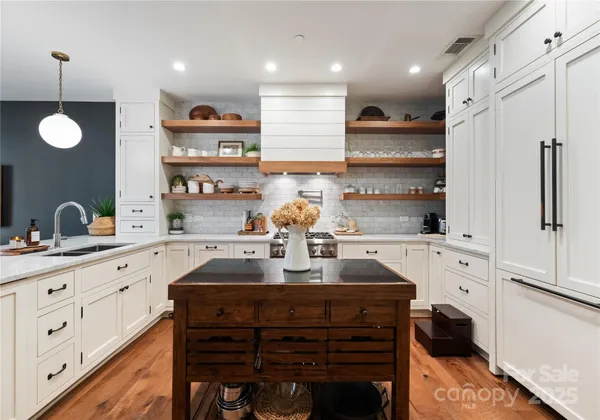a kitchen with a sink cabinets and wooden floor