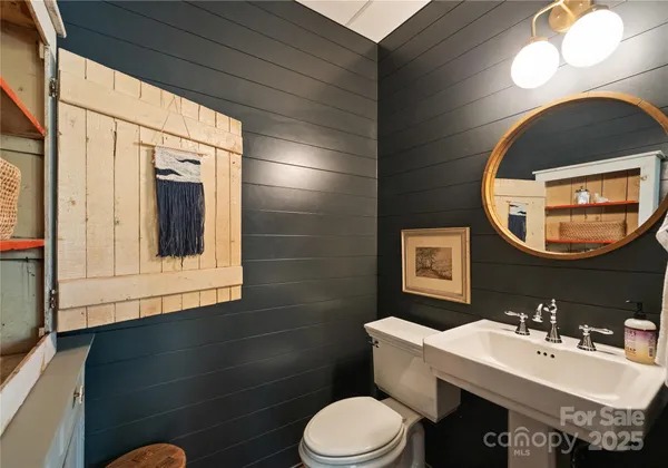 a bathroom with a shower sink and mirror