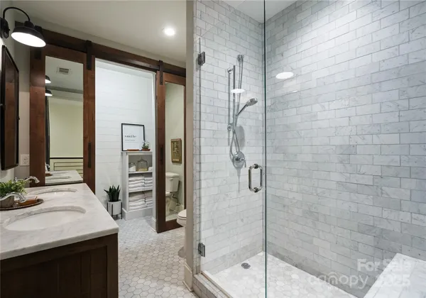 a spacious bathroom with a granite countertop sink and a mirror