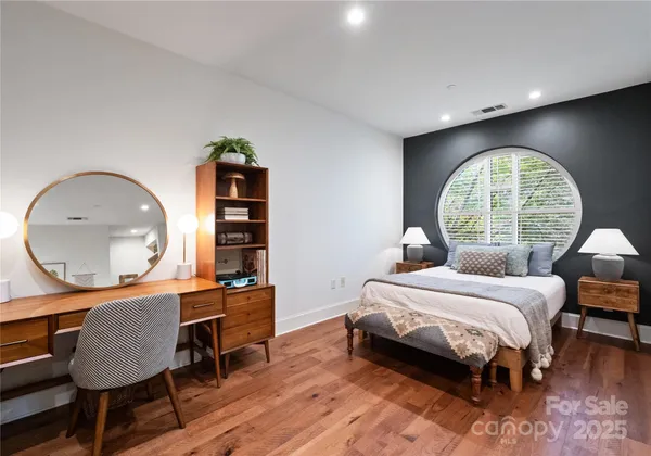 a bedroom with furniture and wooden floor
